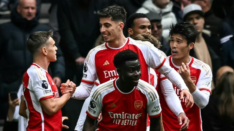 Arsenal survive Spurs fightback to boost title charge