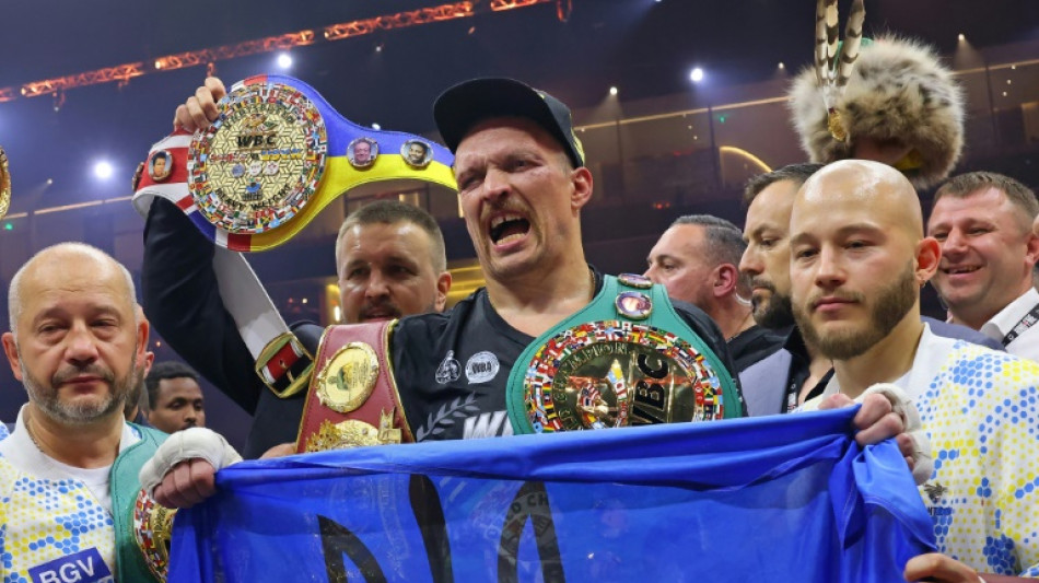 Usyk in tears for late father after historic heavyweight win